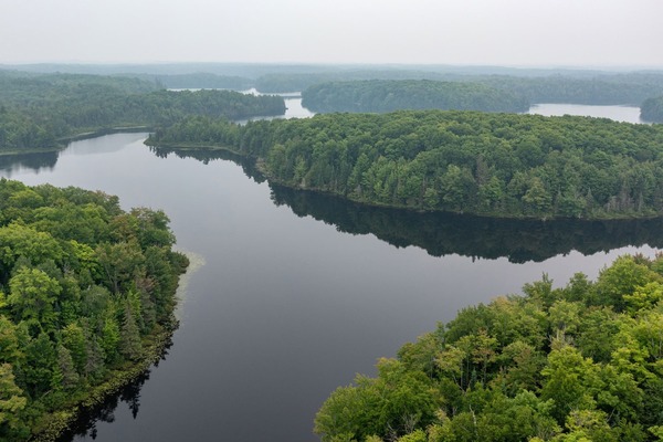 A drone shot shows a sample of the forest and lakes at the University of Notre Dame Environmental Research Center (UNDERC).